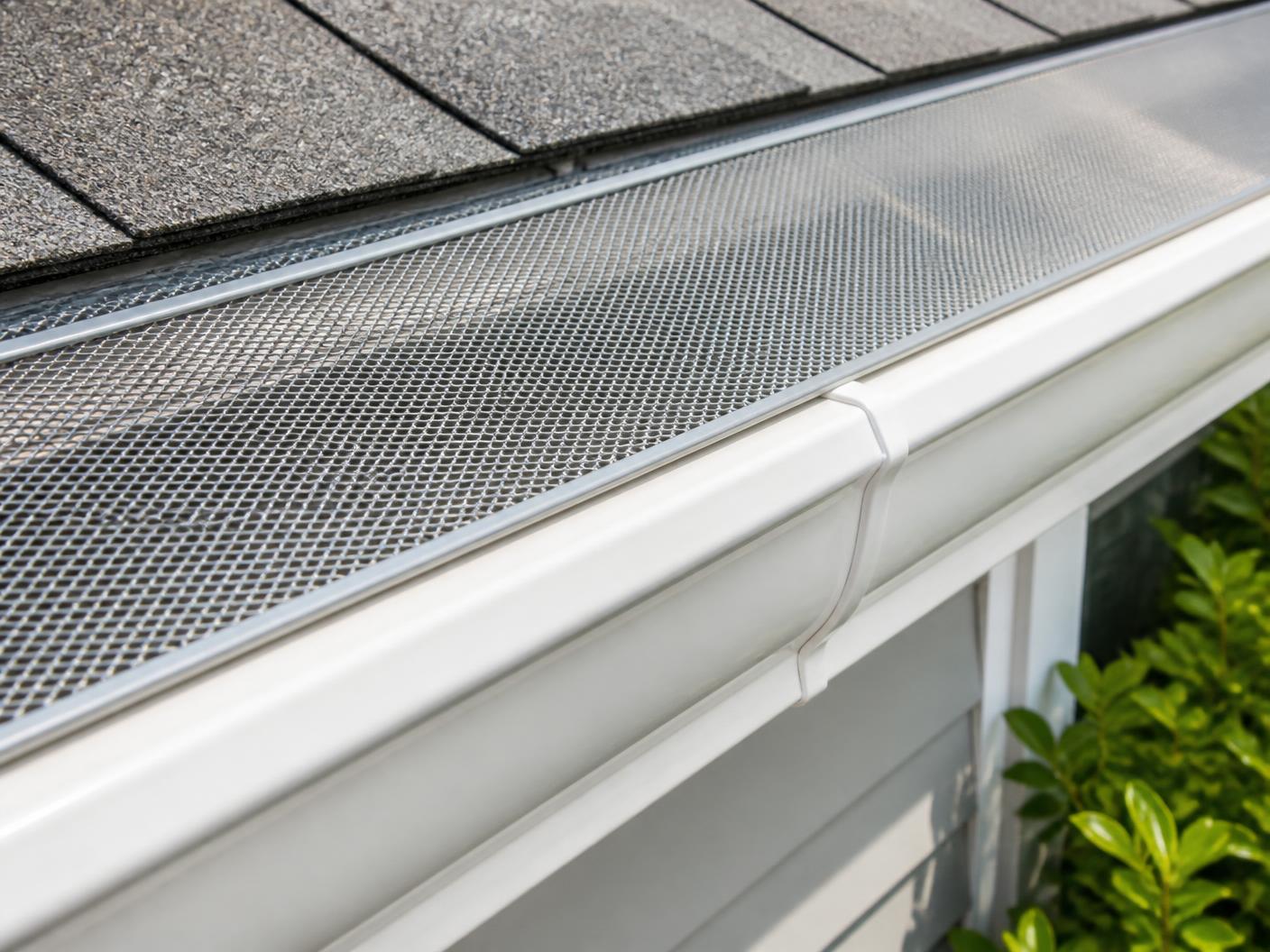 Micro-mesh gutter guard installed over a clean white residential gutter